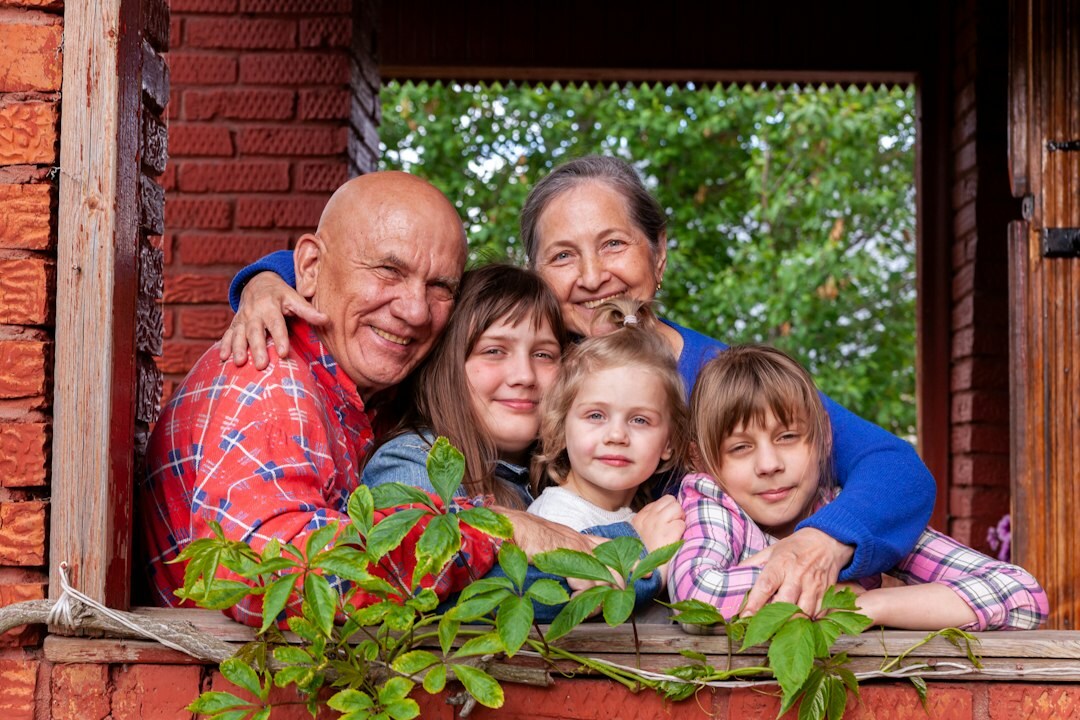Three generations of a Mexican family smiling together outdoors